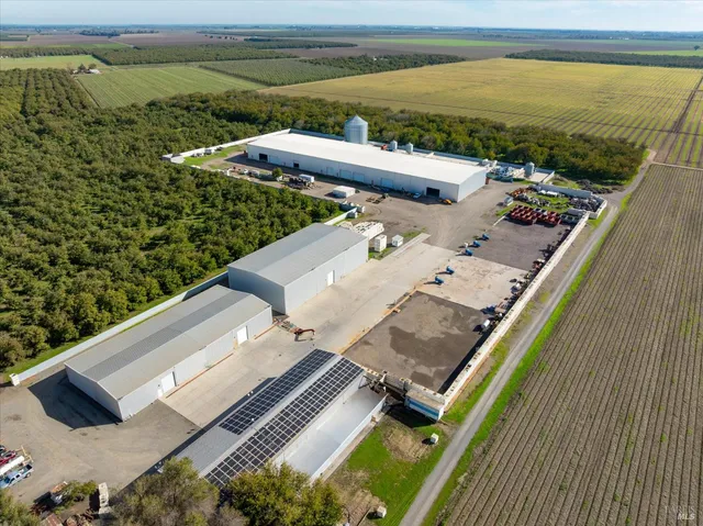 an aerial view of a house with a yard and swimming pool