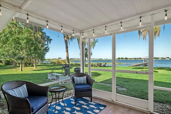 a view of a porch with furniture and yard