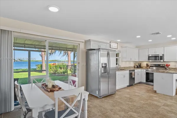 a kitchen with a table and chairs