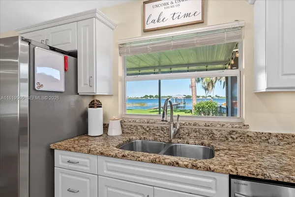 a kitchen with granite countertop a sink and a window