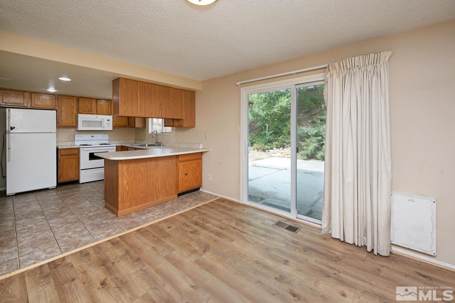 1675 Kings Row Reno, NV 89503 - Photo 12 of 32 a kitchen with stainless steel appliances granite countertop a stove a sink and a refrigerator