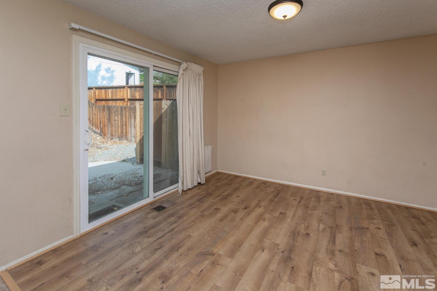 1675 Kings Row Reno, NV 89503 - Photo 13 of 32 an empty room with wooden floor and windows