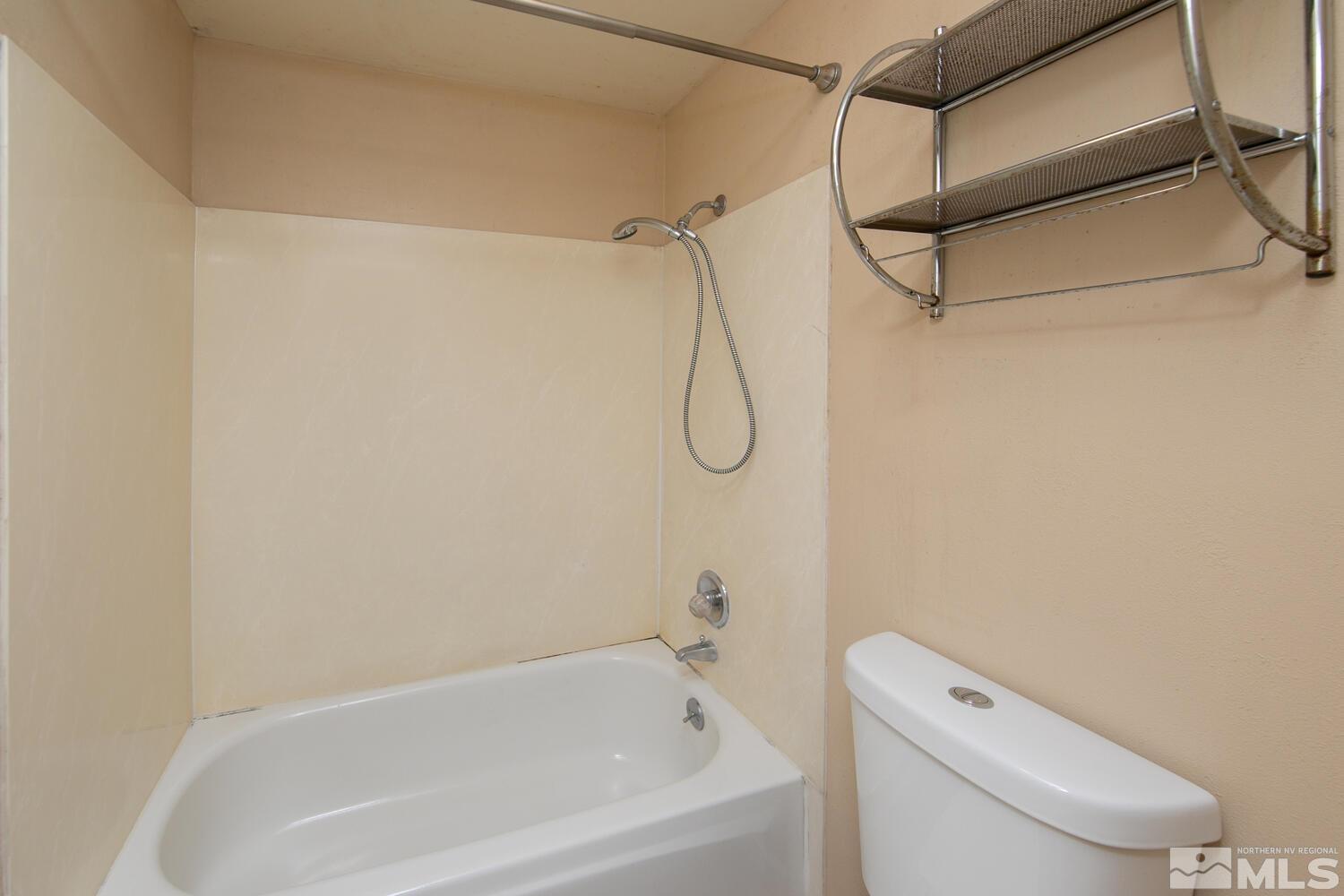1675 Kings Row Reno, NV 89503 - Photo 17 of 32 a bathroom with a bath tub with toilet and a shower