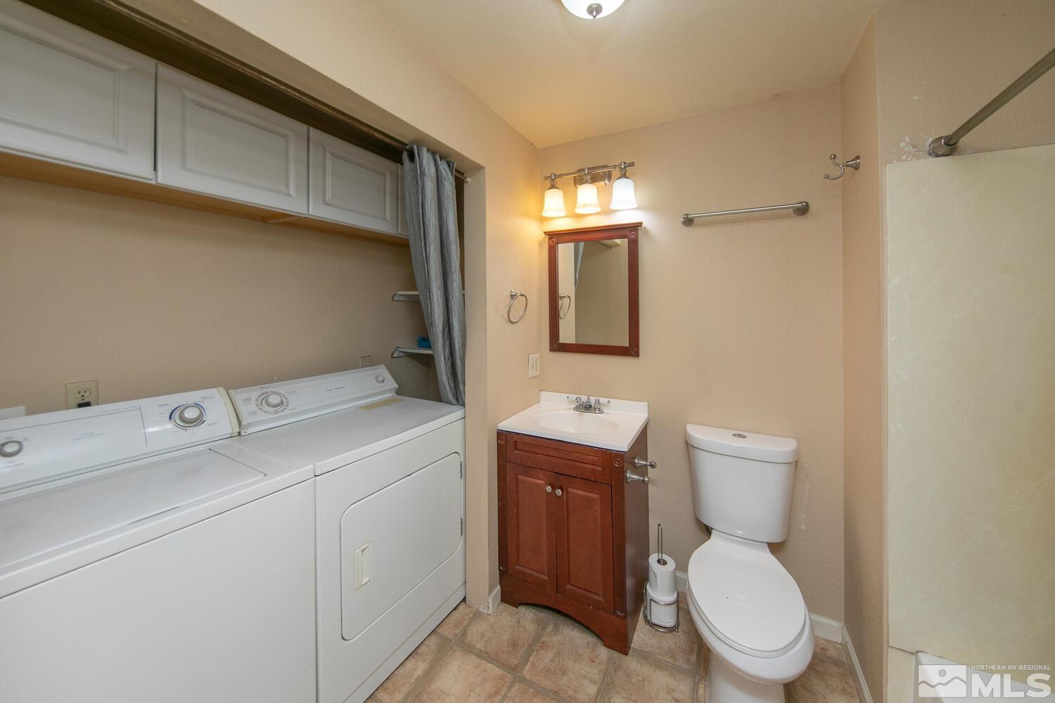 1675 Kings Row Reno, NV 89503 - Photo 18 of 32 a view of bathroom with a toilet sink and mirror