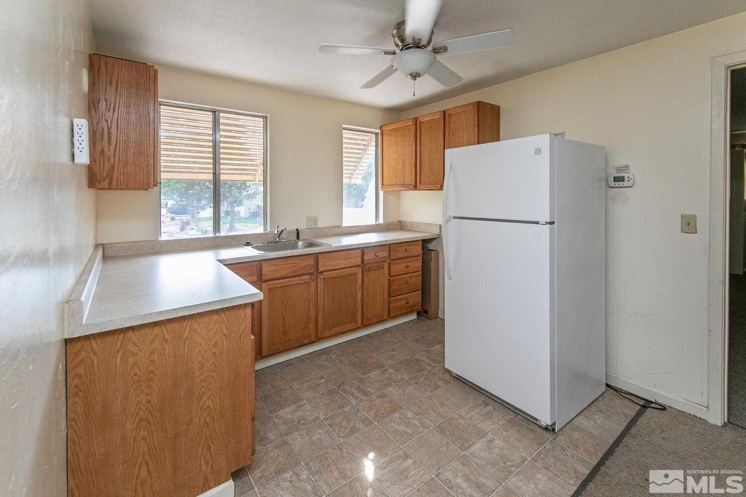 1675 Kings Row Reno, NV 89503 - Photo 25 of 32 a kitchen with a refrigerator a sink and dishwasher