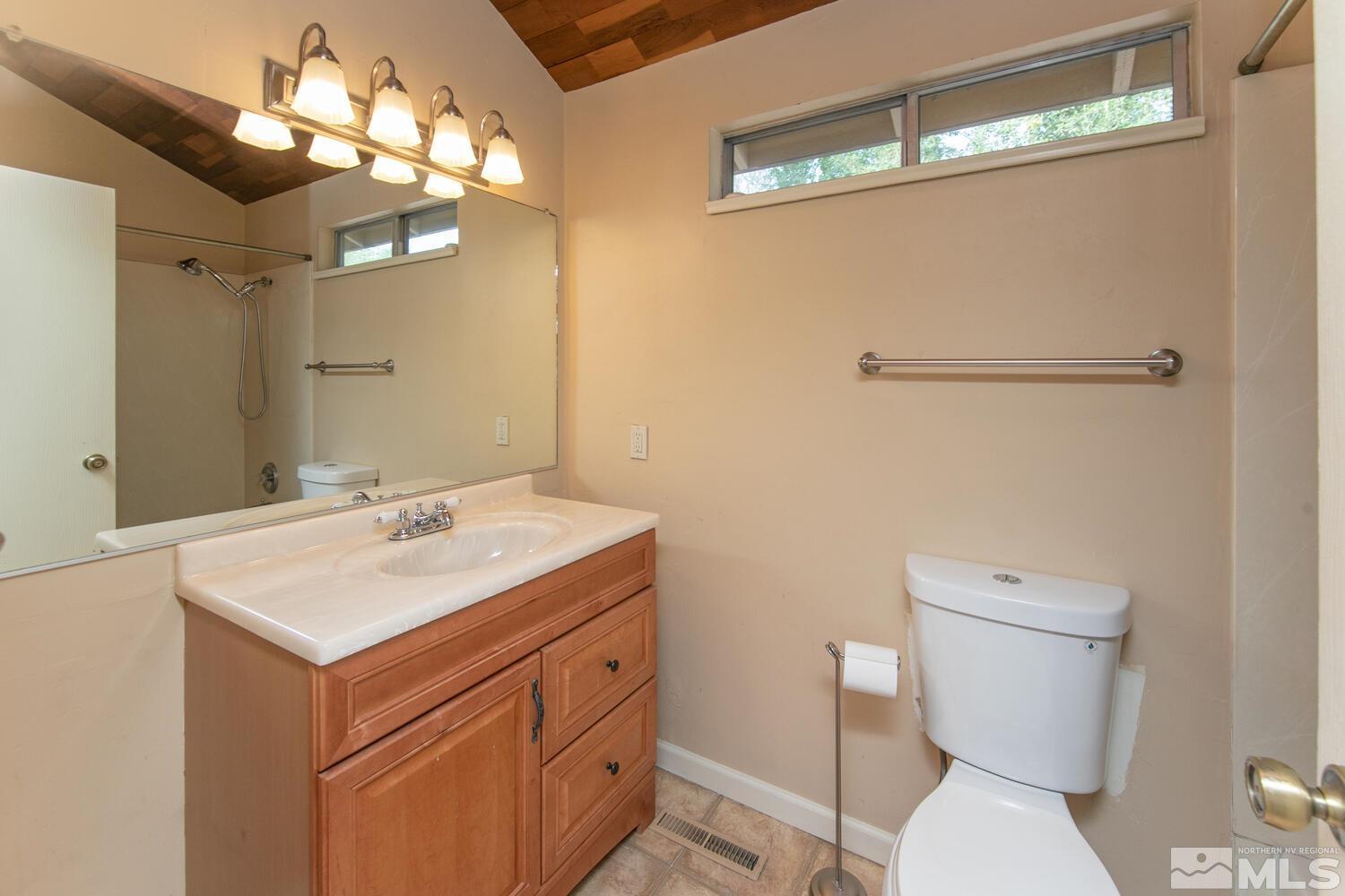 1675 Kings Row Reno, NV 89503 - Photo 28 of 32 a bathroom with a toilet sink and mirror
