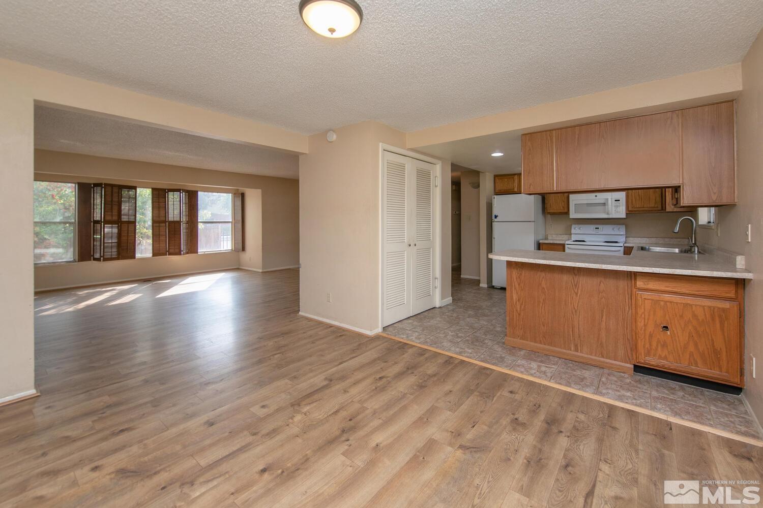 1675 Kings Row Reno, NV 89503 - Photo 5 of 32 a large kitchen with stainless steel appliances granite countertop a stove a sink and a refrigerator