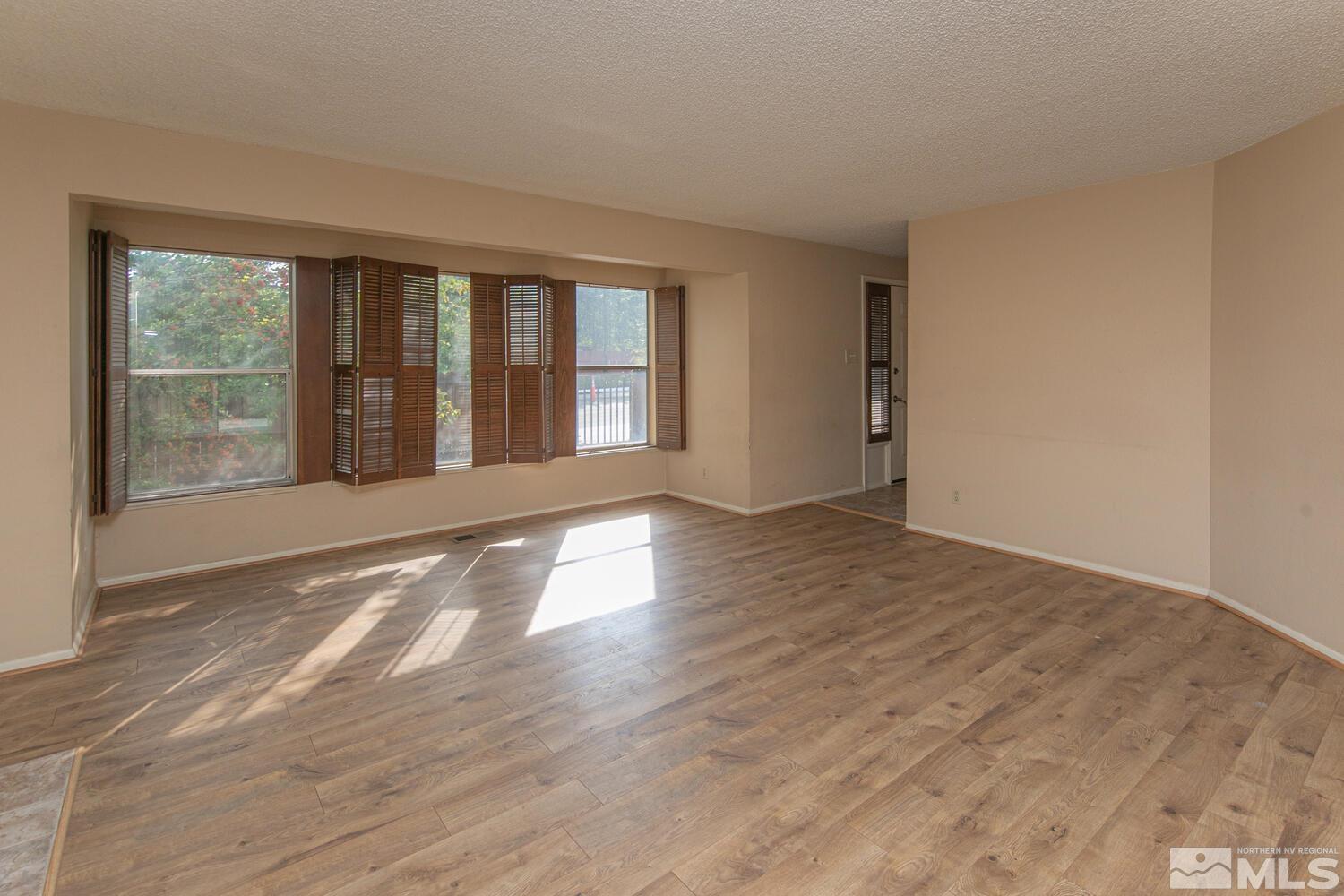 1675 Kings Row Reno, NV 89503 - Photo 6 of 32 a view of an empty room with wooden floor and a window