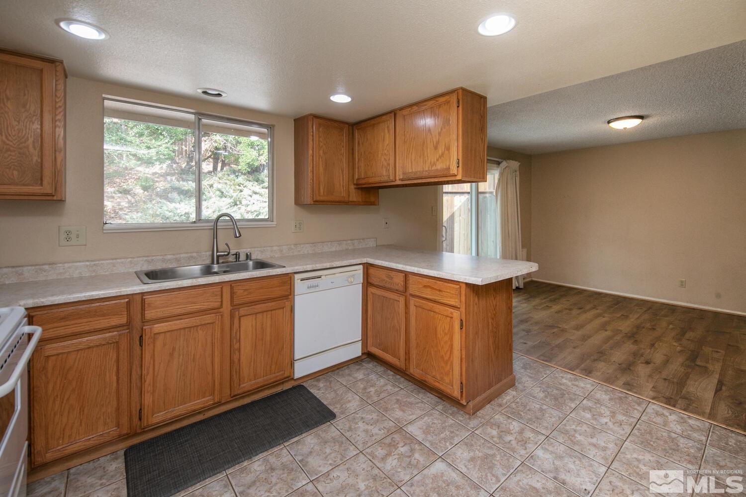 1675 Kings Row Reno, NV 89503 - Photo 9 of 32 a kitchen with stainless steel appliances granite countertop a stove a sink and a refrigerator