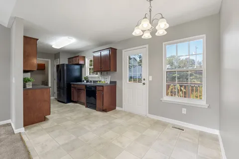 a kitchen with stainless steel appliances granite countertop a refrigerator and a sink