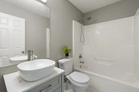 an empty room with closet and a chandelier fan