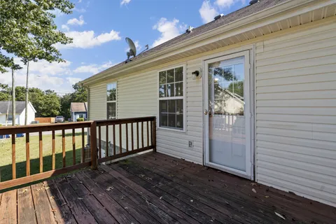 a balcony with furniture and wooden floor