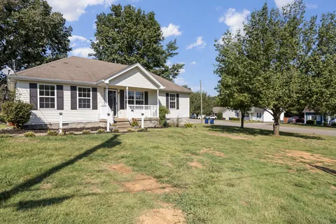 a front view of a house with a yard and porch