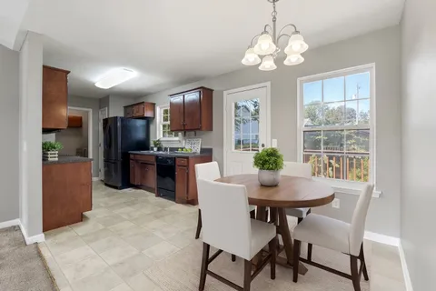 a kitchen with kitchen island a dining table and stainless steel appliances