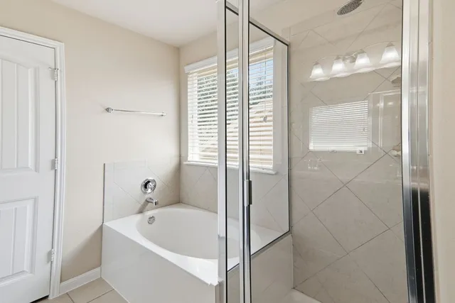 a bathroom with a bathtub and shower