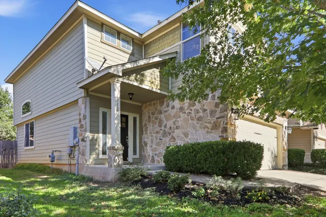 a view of a house with a yard and sitting area