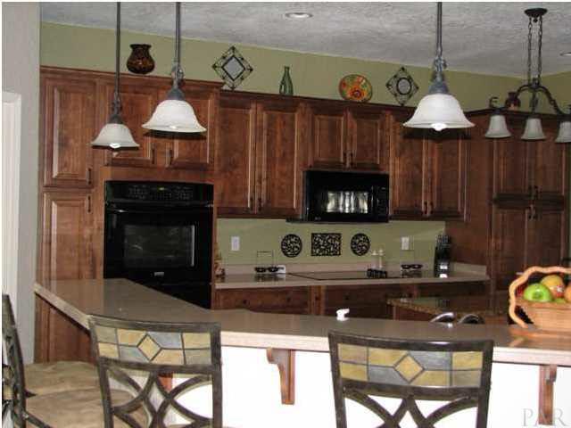 6417 Brigadier Road Milton, FL 32570 - Photo 8 of 25 Breakfast bar with solid surface counter tops.