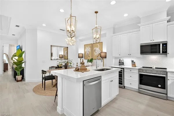 a kitchen with a sink a stove and chairs
