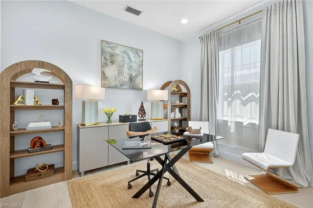 a living room with furniture a rug and a window