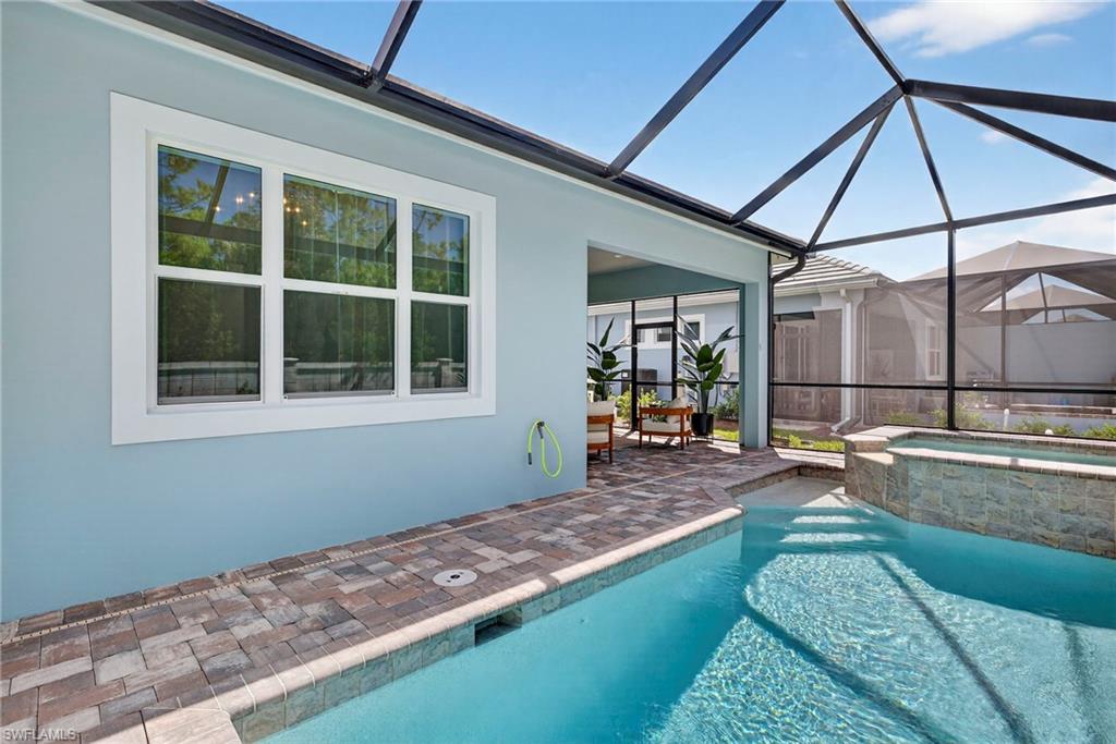 8877 Yucatan Court Naples, FL 34113 - Photo 29 of 29 a view of a backyard with a swimming pool