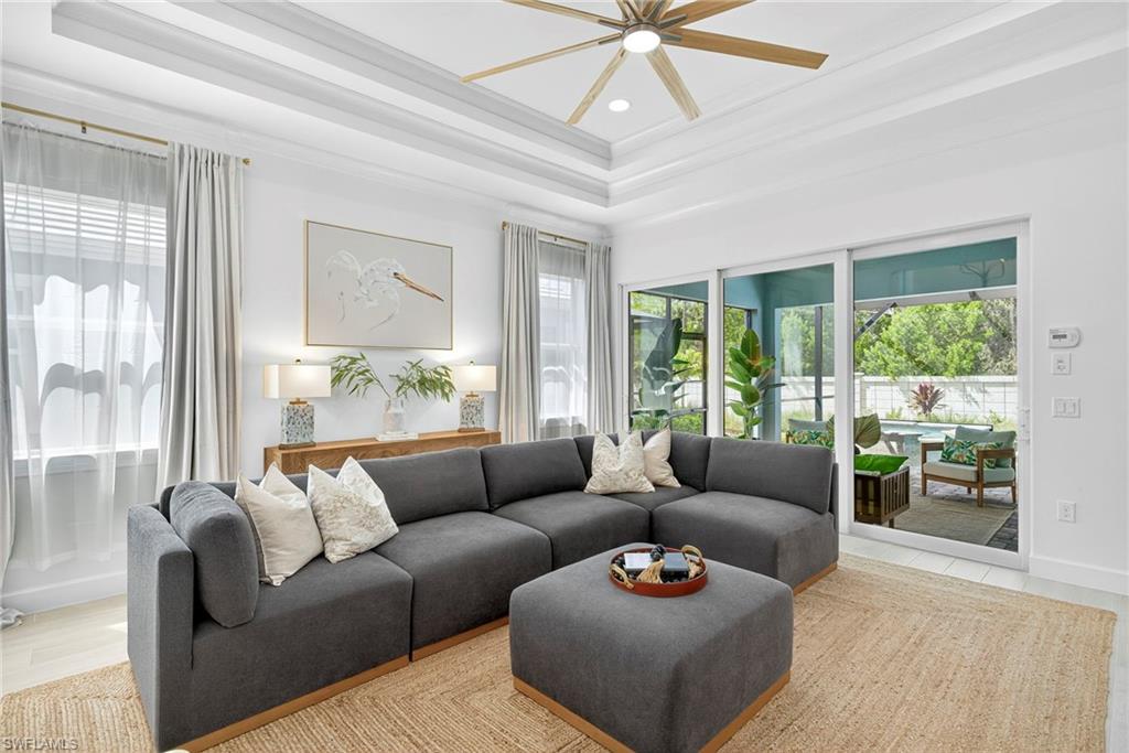 8877 Yucatan Court Naples, FL 34113 - Photo 3 of 29 a living room with furniture and a large window