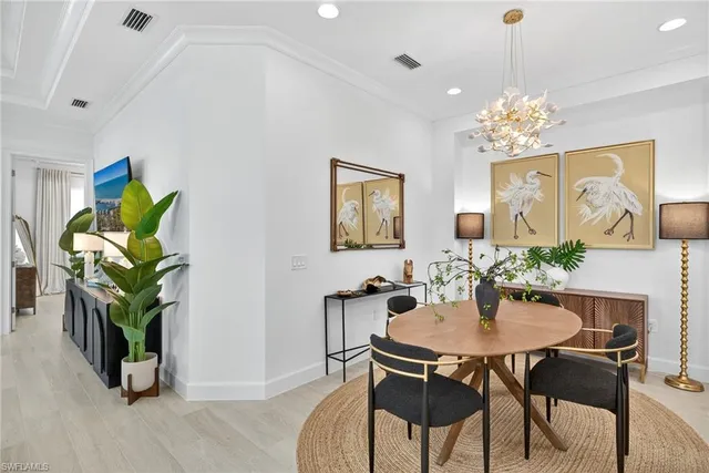 a dining room with furniture and potted plants