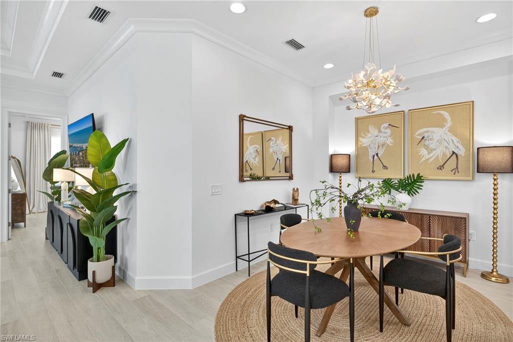 8877 Yucatan Court Naples, FL 34113 - Photo 7 of 29 a dining room with furniture and potted plants