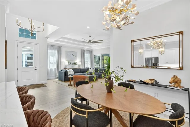 a view of a dining room with furniture and chandelier