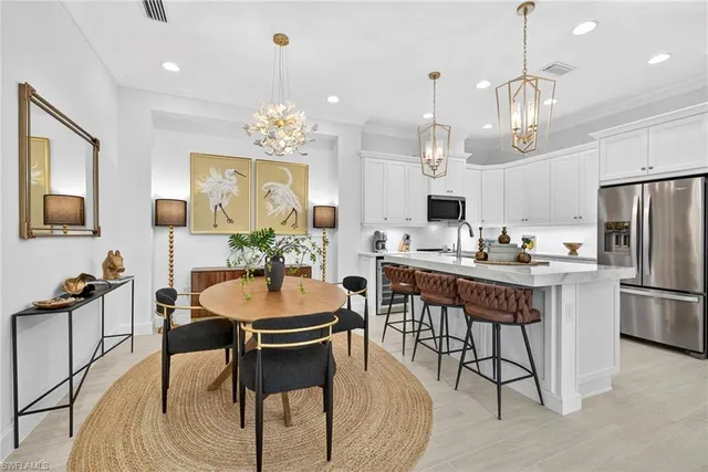 a view of a dining room with furniture a chandelier and wooden floor