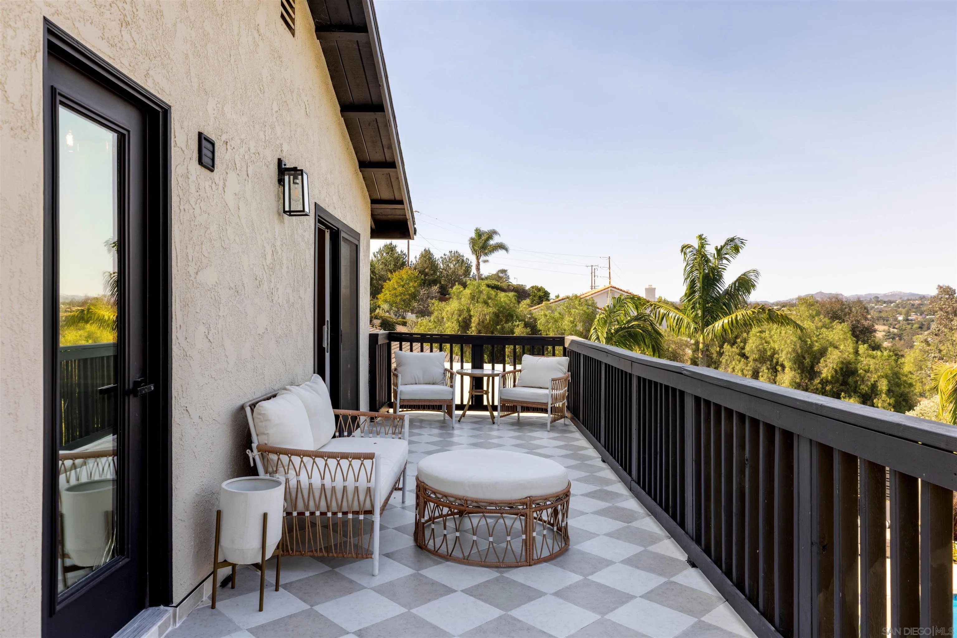 521 Rancho Camino Fallbrook, CA 92028 - Photo 36 of 72 a view of a balcony with chairs and iron fence
