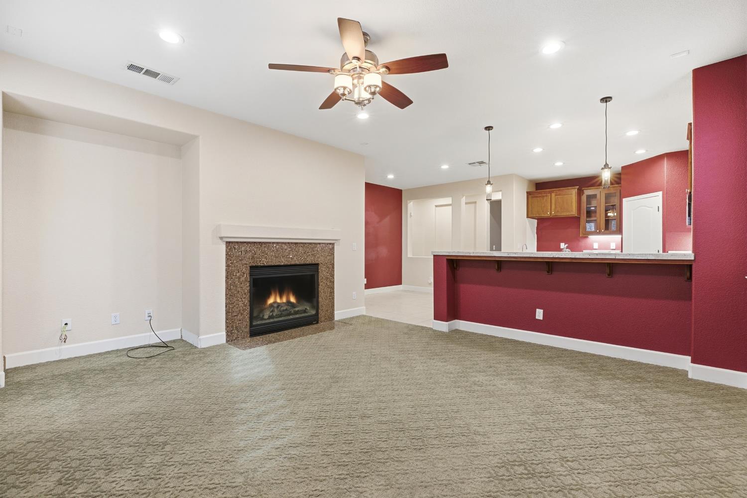 2609 Amir Drive Modesto, CA 95355 - Photo 12 of 36 a kitchen with kitchen island stainless steel appliances a chimney a counter top and ceiling fan