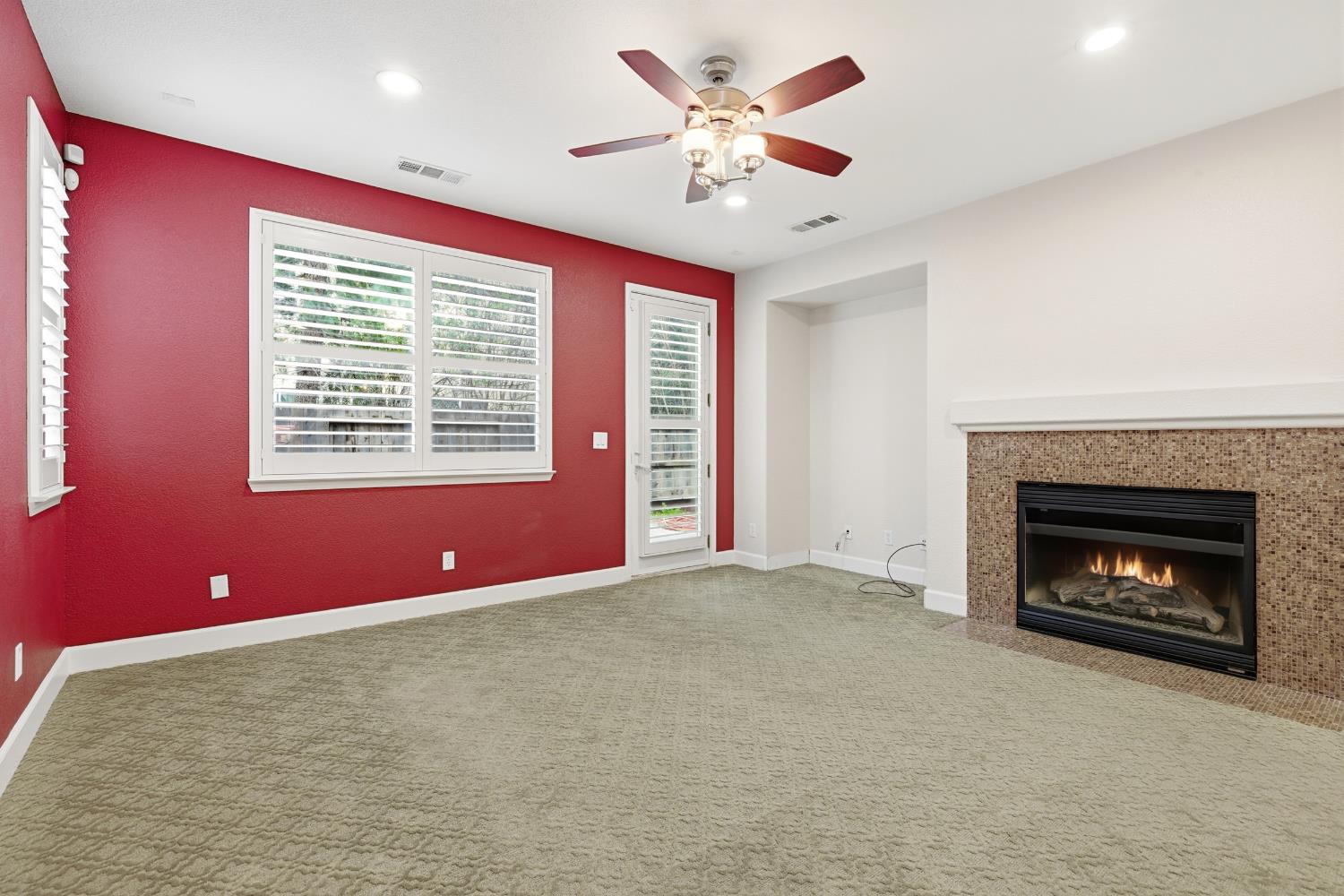 2609 Amir Drive Modesto, CA 95355 - Photo 13 of 36 a view of an empty room with a fireplace and a ceiling fan