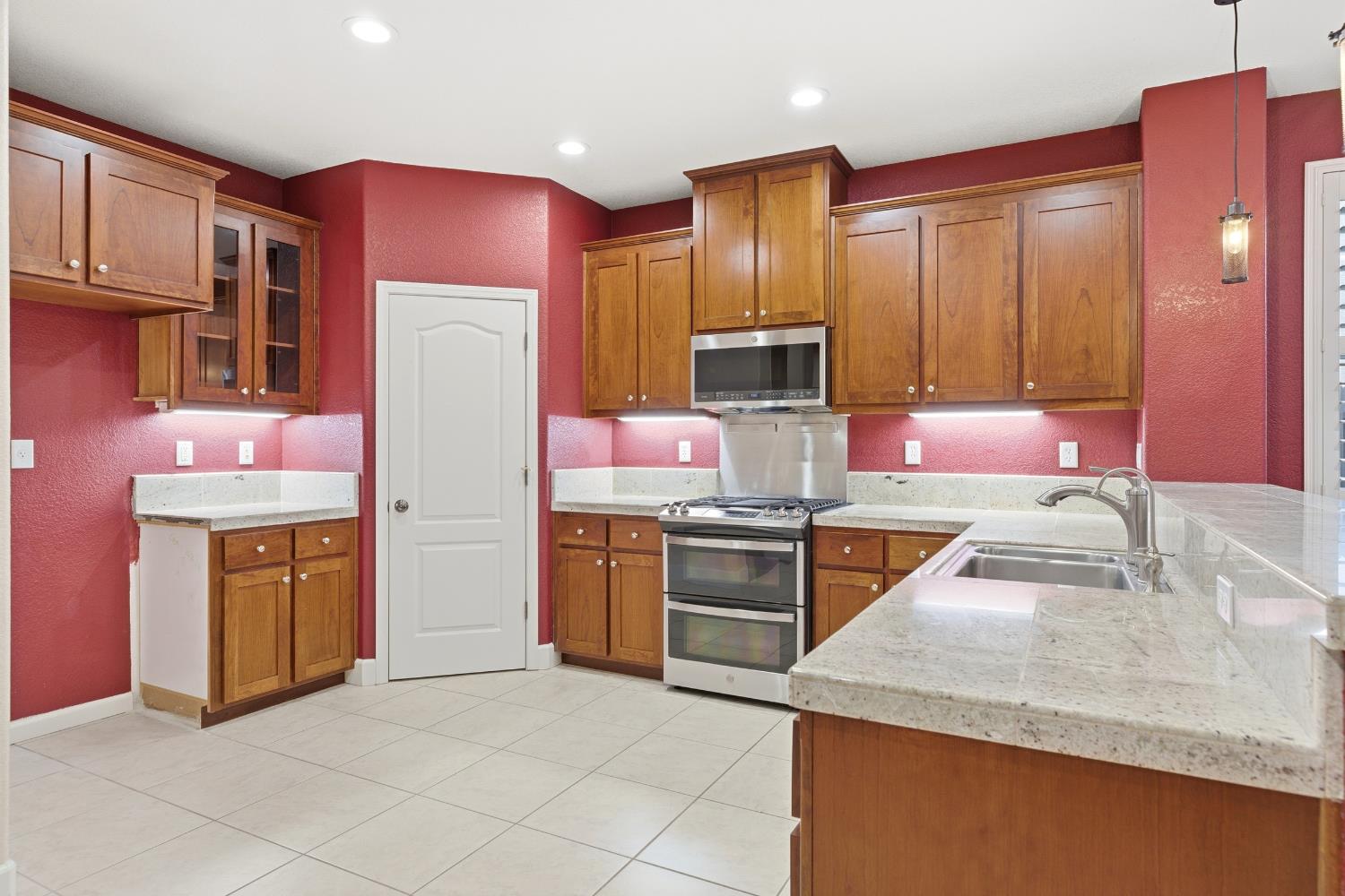 2609 Amir Drive Modesto, CA 95355 - Photo 14 of 36 a kitchen with stainless steel appliances granite countertop a sink stove and refrigerator