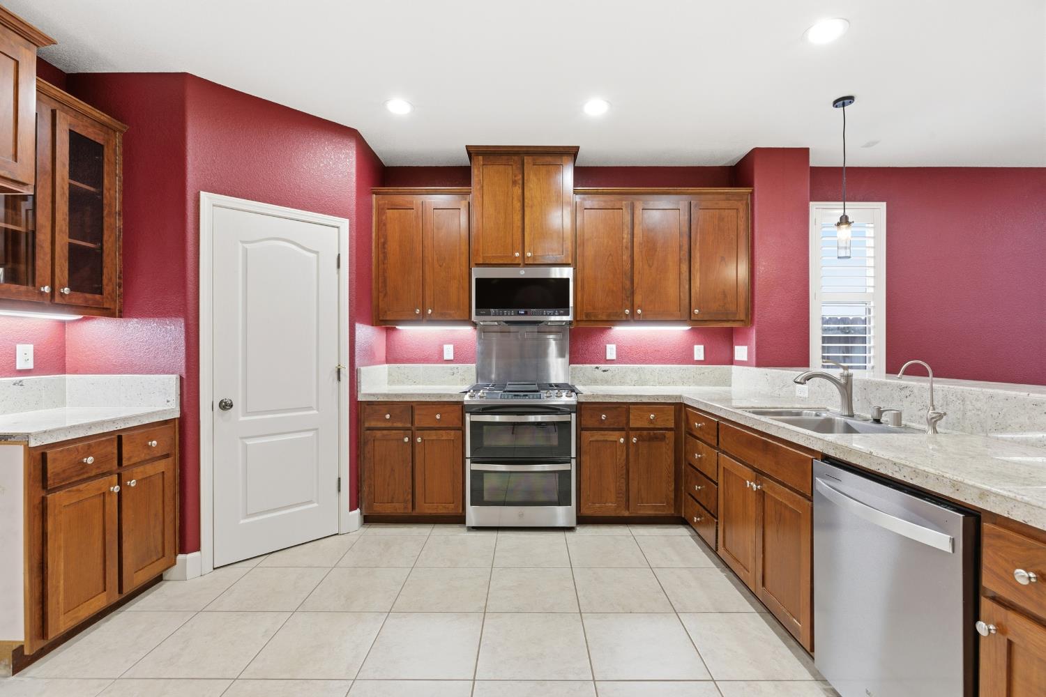 2609 Amir Drive Modesto, CA 95355 - Photo 15 of 36 a kitchen with stainless steel appliances granite countertop a stove top oven sink and refrigerator