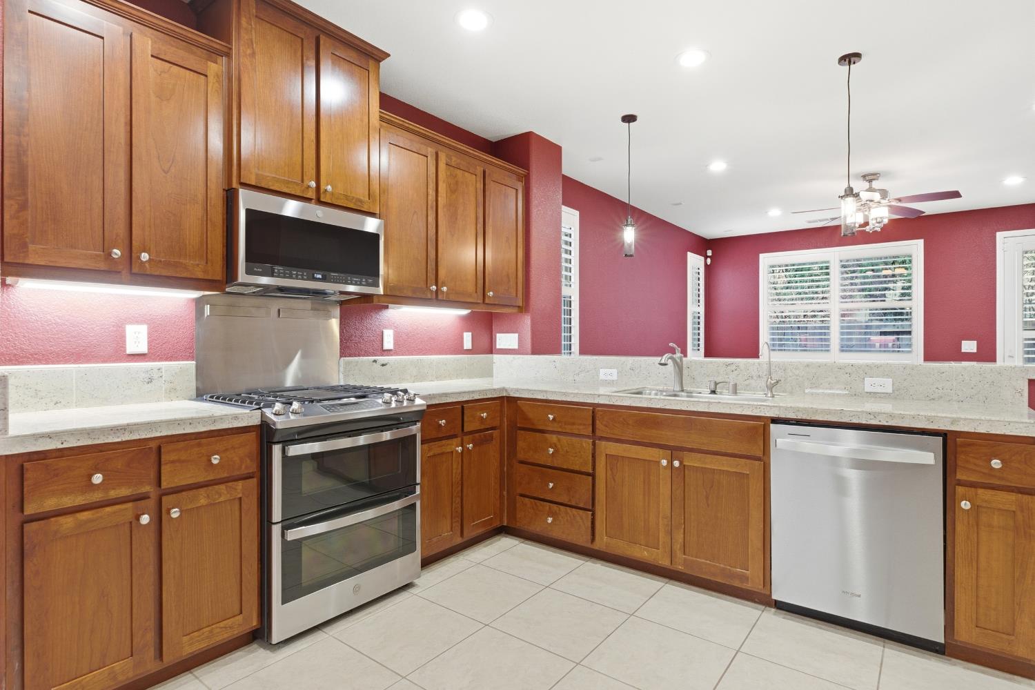 2609 Amir Drive Modesto, CA 95355 - Photo 16 of 36 a kitchen with granite countertop cabinets stainless steel appliances and a sink