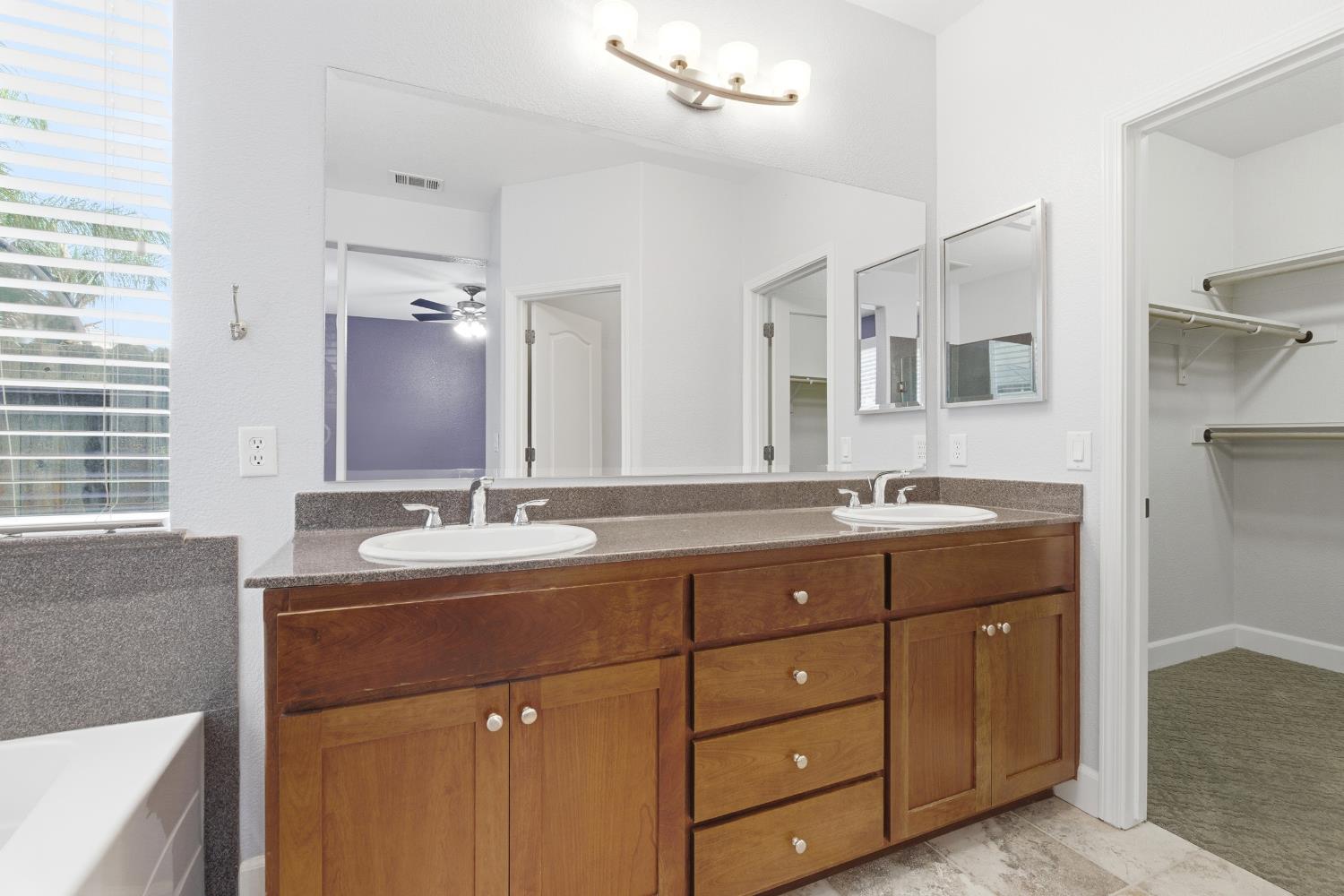 2609 Amir Drive Modesto, CA 95355 - Photo 26 of 36 a bathroom with a granite countertop sink double vanity and a mirror