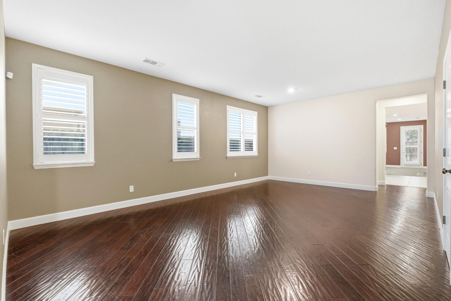 2609 Amir Drive Modesto, CA 95355 - Photo 7 of 36 a view of an empty room with wooden floor and a window