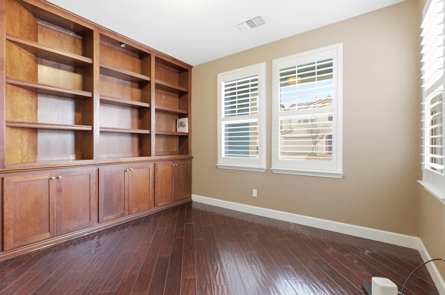 2609 Amir Drive Modesto, CA 95355 - Photo 9 of 36 a view of an empty room with a window and wooden floor