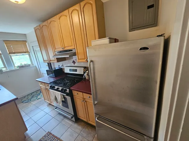 a kitchen with stainless steel appliances a stove and a refrigerator