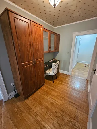 a view of a room with wooden floor and chair
