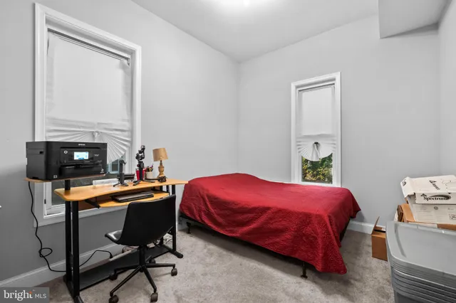 a bedroom with a bed and a desk