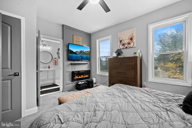 a bedroom with a bed and a television