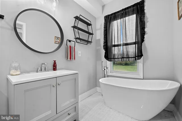 a bathroom with a bathtub and a sink