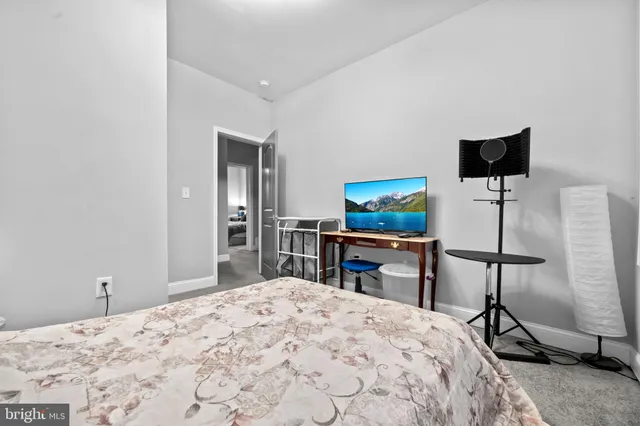 a bedroom with a bed and a television