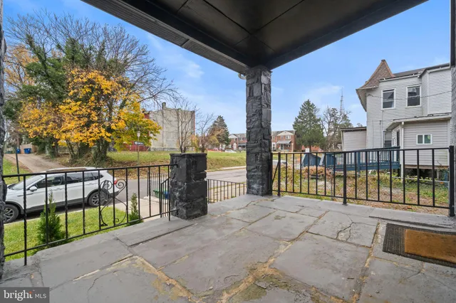 a view of a balcony with a floor to ceiling window and wooden fence