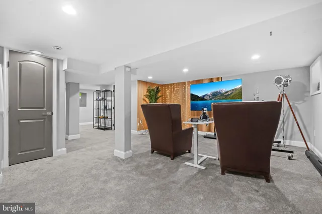 a view of a room with furniture and a refrigerator