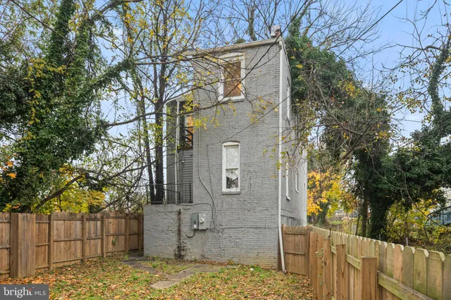 front view of a house with large trees