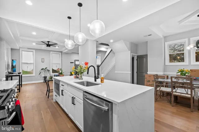 a large kitchen with a table and chairs