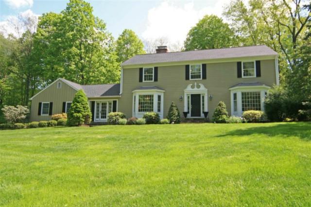 7 Lounsbury Road Ridgefield, CT 06877 - Photo 1 of 1 a front view of a house with a garden