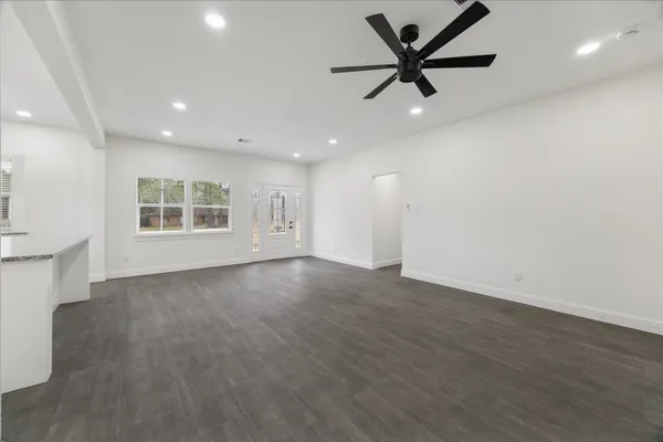 a view of a kitchen with wooden floor and window